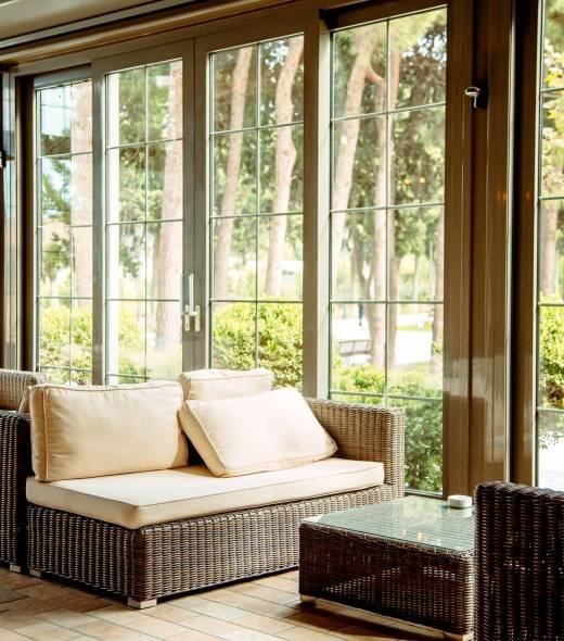 outdoor sofa with beige cushions and coffee table in front of the restaurant window